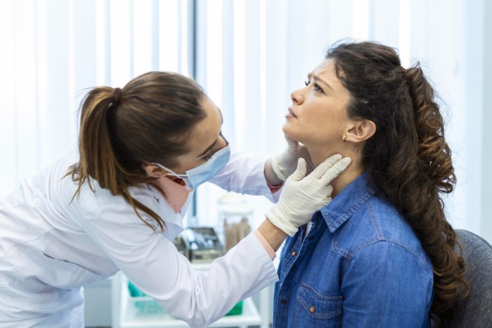 a doctor treating a thyroid patient