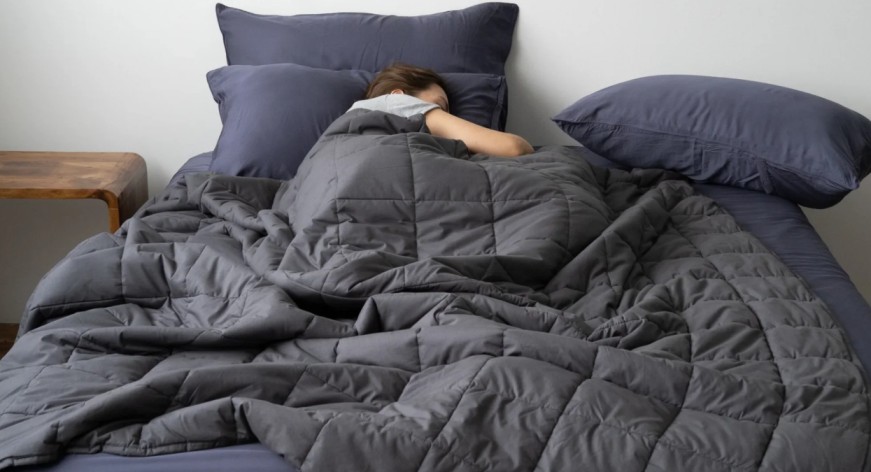 a woman curled up in a therapy blanket